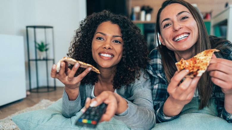 Girls eating and watching TV