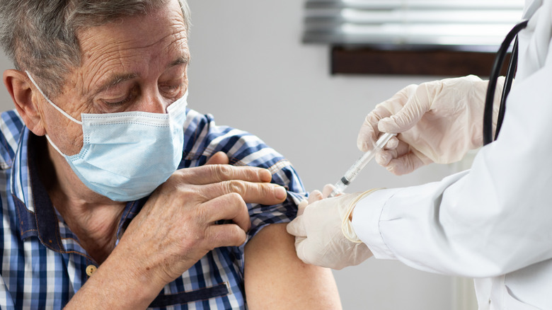 An older man getting vaccinated