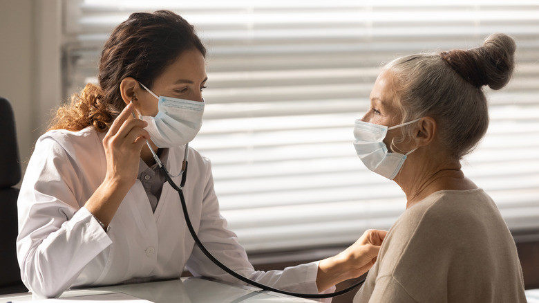 doctor listening to patient's heart