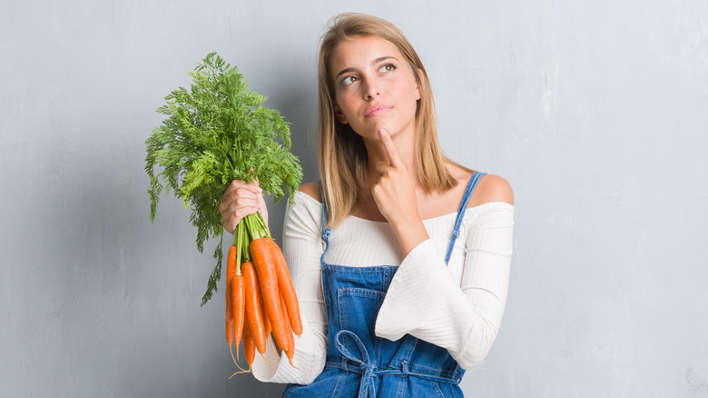 woman holding carrots