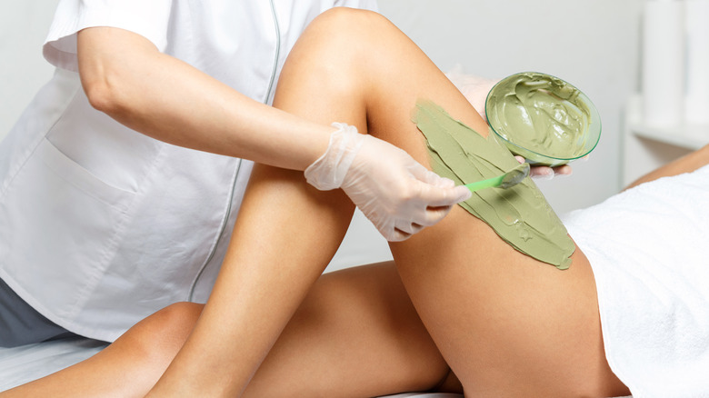 Seaweed mud mask applied to leg
