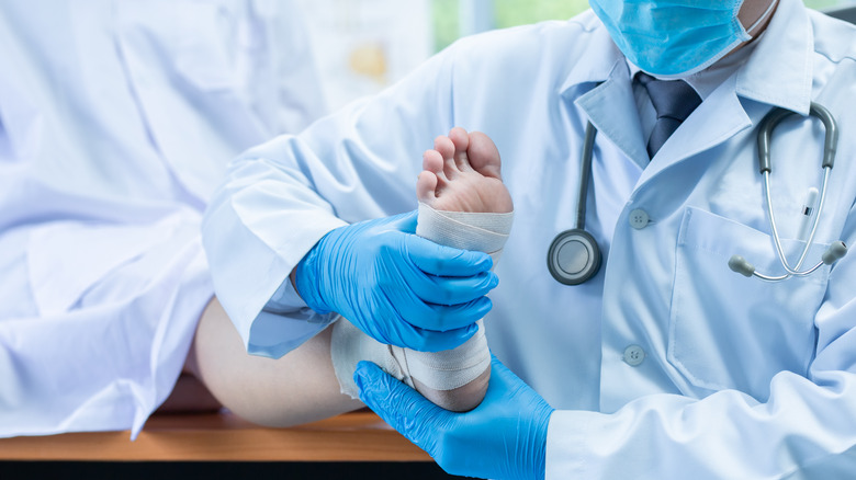 doctor examining foot for bone spurs