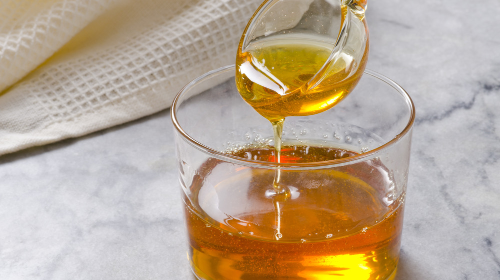 agave syrup being poured into tea