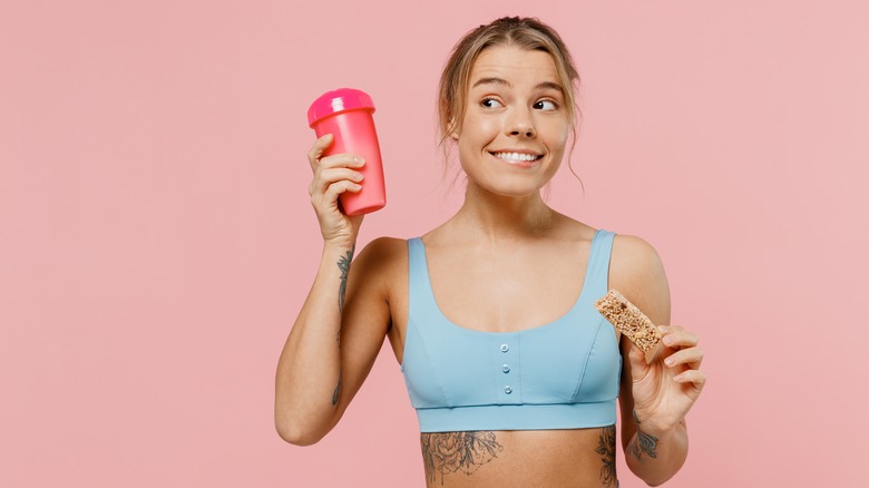 woman holding up protein 