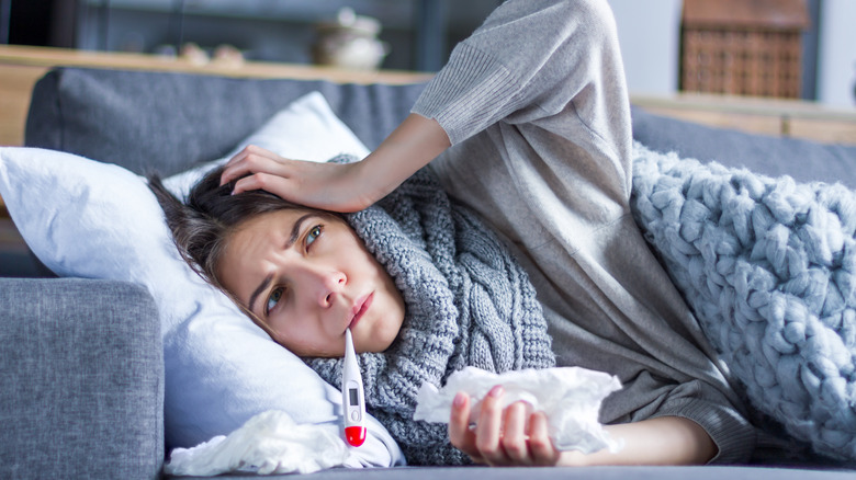 Woman sick on couch