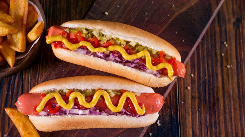 Two hot dogs with toppings