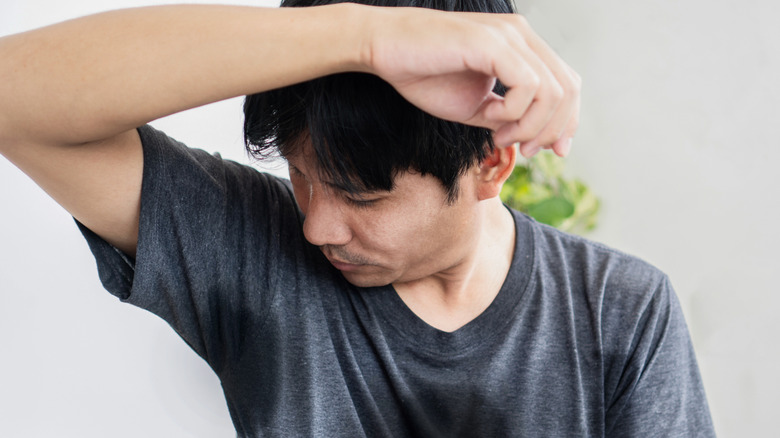 Man checking his body odor