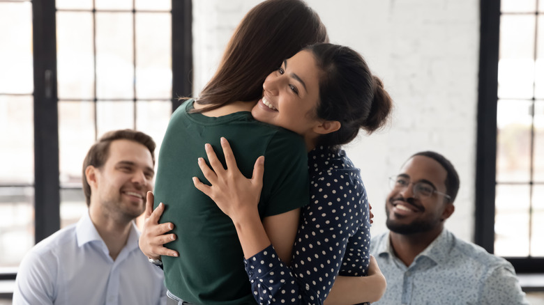 people hugging at group therapy