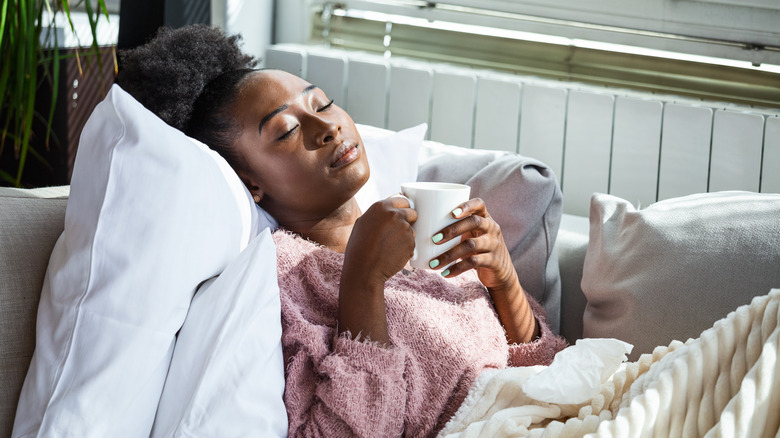 Black woman resting on couch