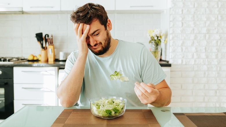 man eating salad