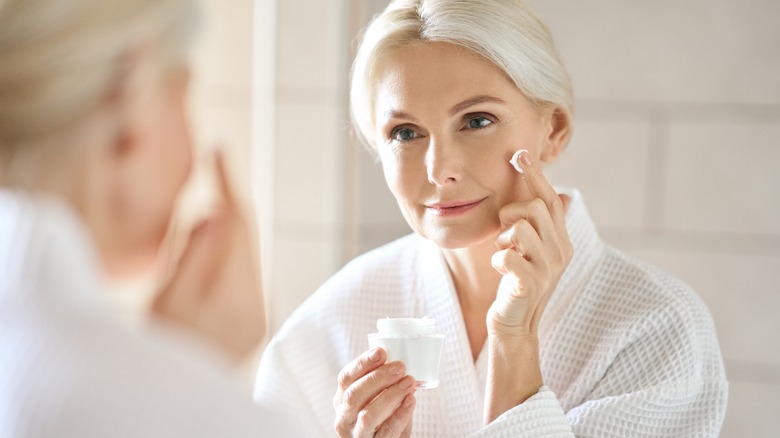 Older woman looking in mirror