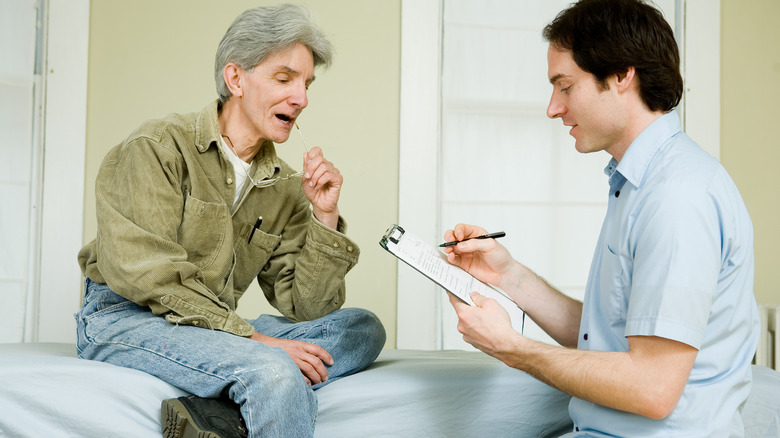 man speaking to massage therapist