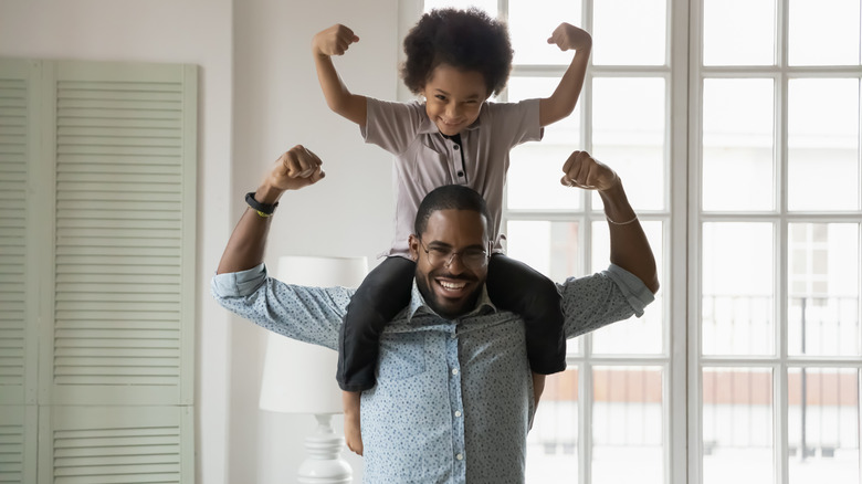 son and father flexing muscles 