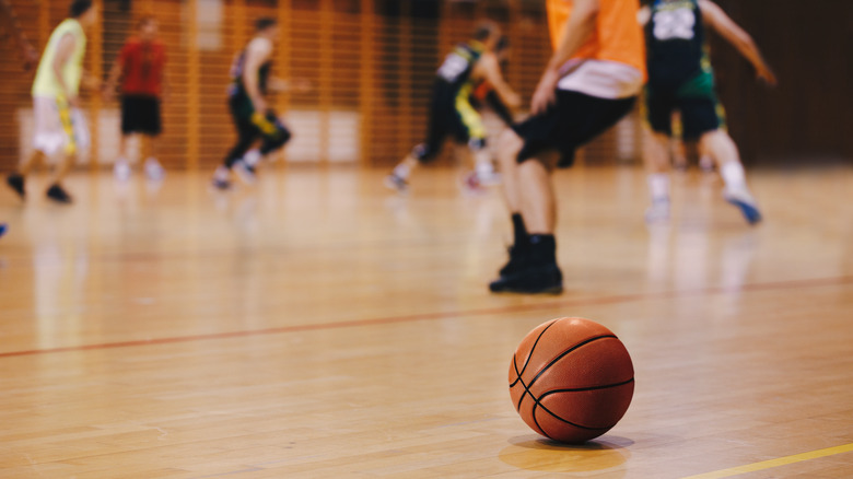 basketball players and basketball on court