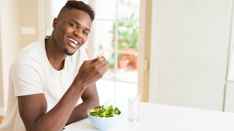 man eating a salad