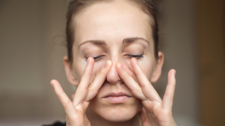 woman touching her nose
