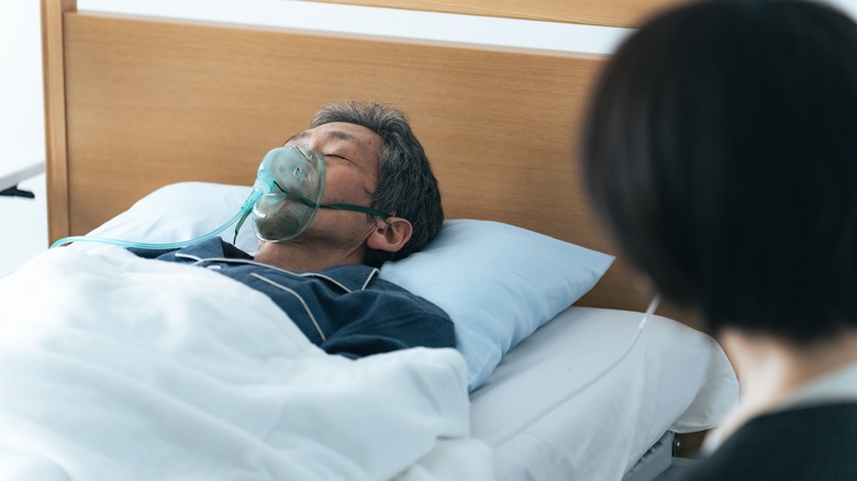 Comatose patient in hospital bed