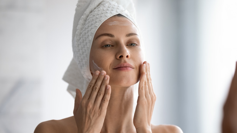 A woman washes her face