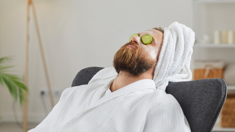 Man with cucumbers over eyes