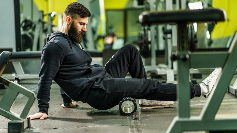 man using foam roller