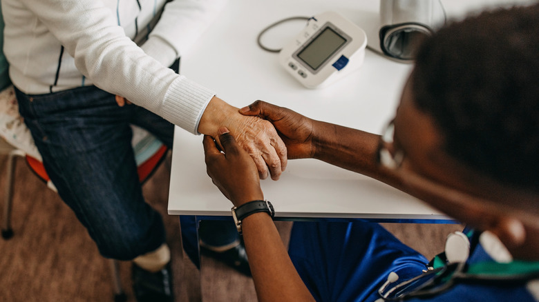 Doctor examining patient hand