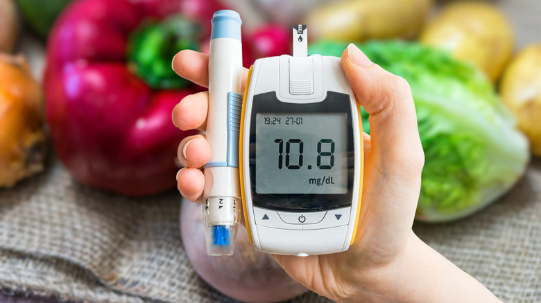 Hand holding glucometer