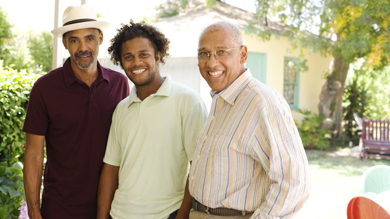 Three men standing outside