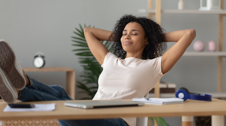 reclining woman at desk with her feet up