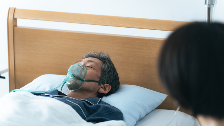 Comatose patient in hospital bed