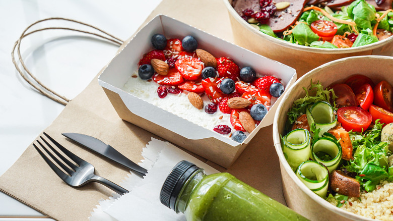 two salads, green juice, and cottage cheese with fruit