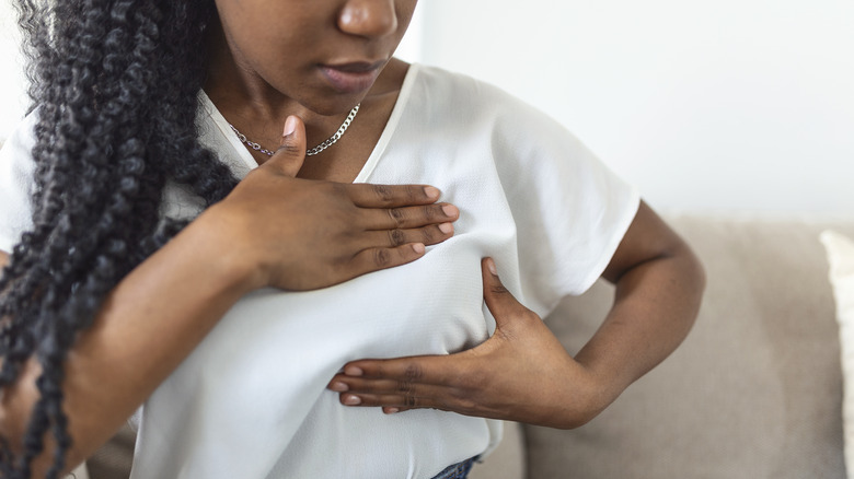 Woman performs breast self exam