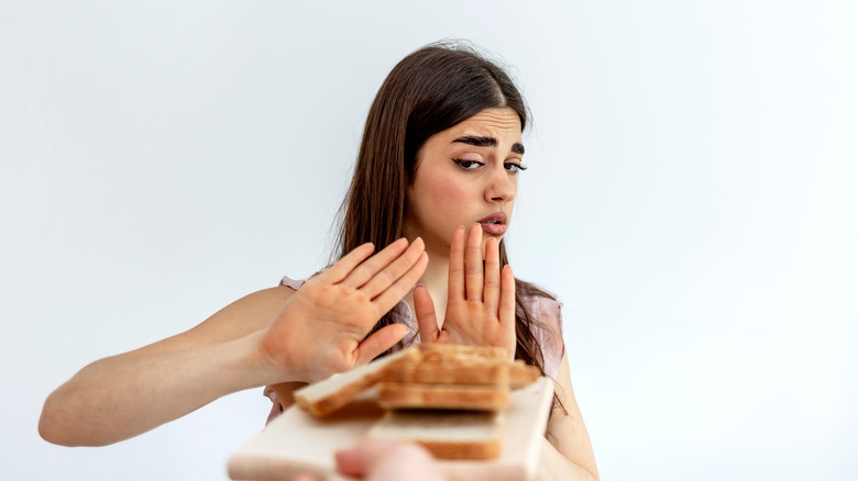 a woman saying no to bread