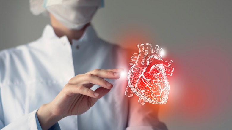 doctor touching virtual heart