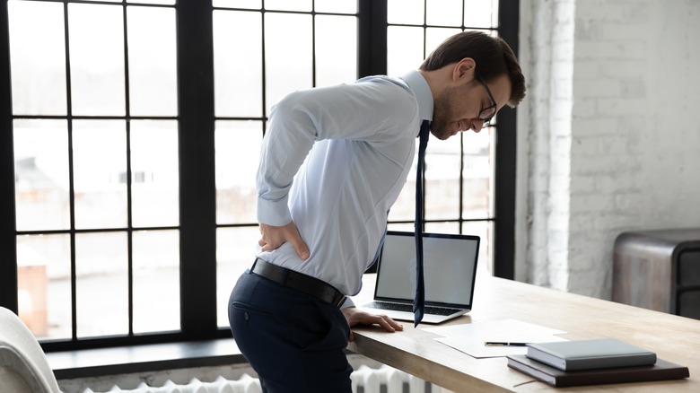 Office worker having sciatica pain in the back 