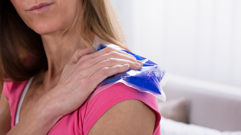 Woman icing shoulder