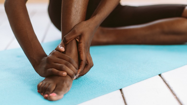 Close-up of hands holding foot
