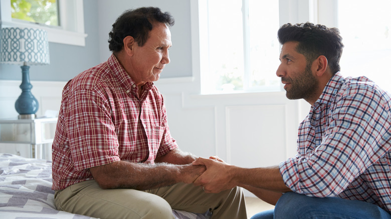 Son comforting father with memory issues