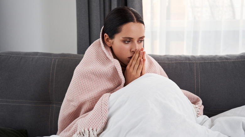 woman in bed with cold symptoms 