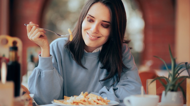 Woman eating pasta