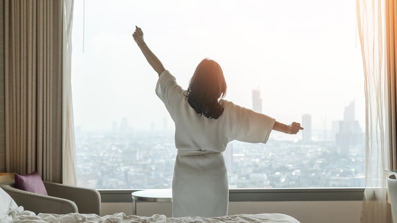 woman stretching after getting out of bed 