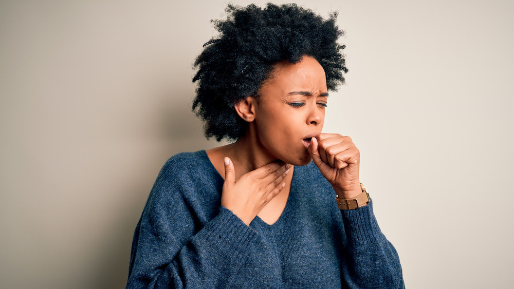 Black woman coughing 
