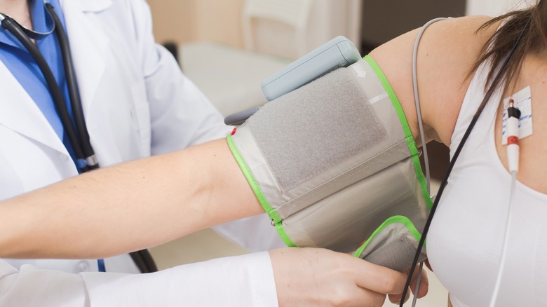 nurse taking patient's blood pressure