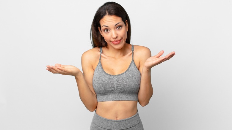 woman with confused expression and workout clothes