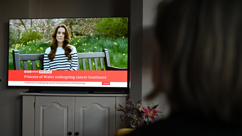 Woman watching news broadcast of Kate Middleton