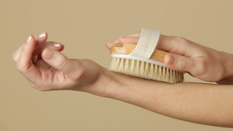woman dry brushing arm