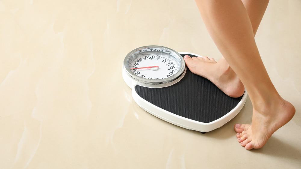 Feet stepping onto a scale