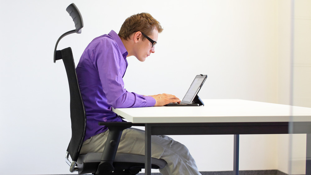 man slouching on computer