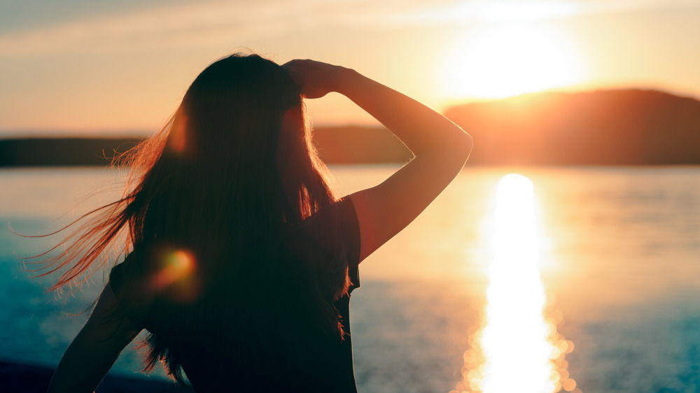 Woman shields her eyes from the sun