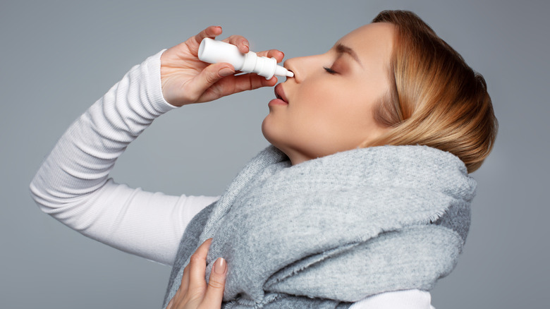 Woman using nasal spray