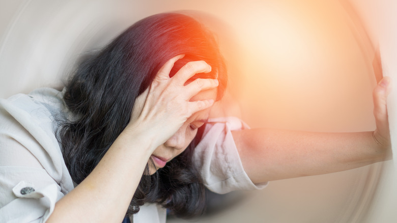 Woman feeling dizzy because of a stroke